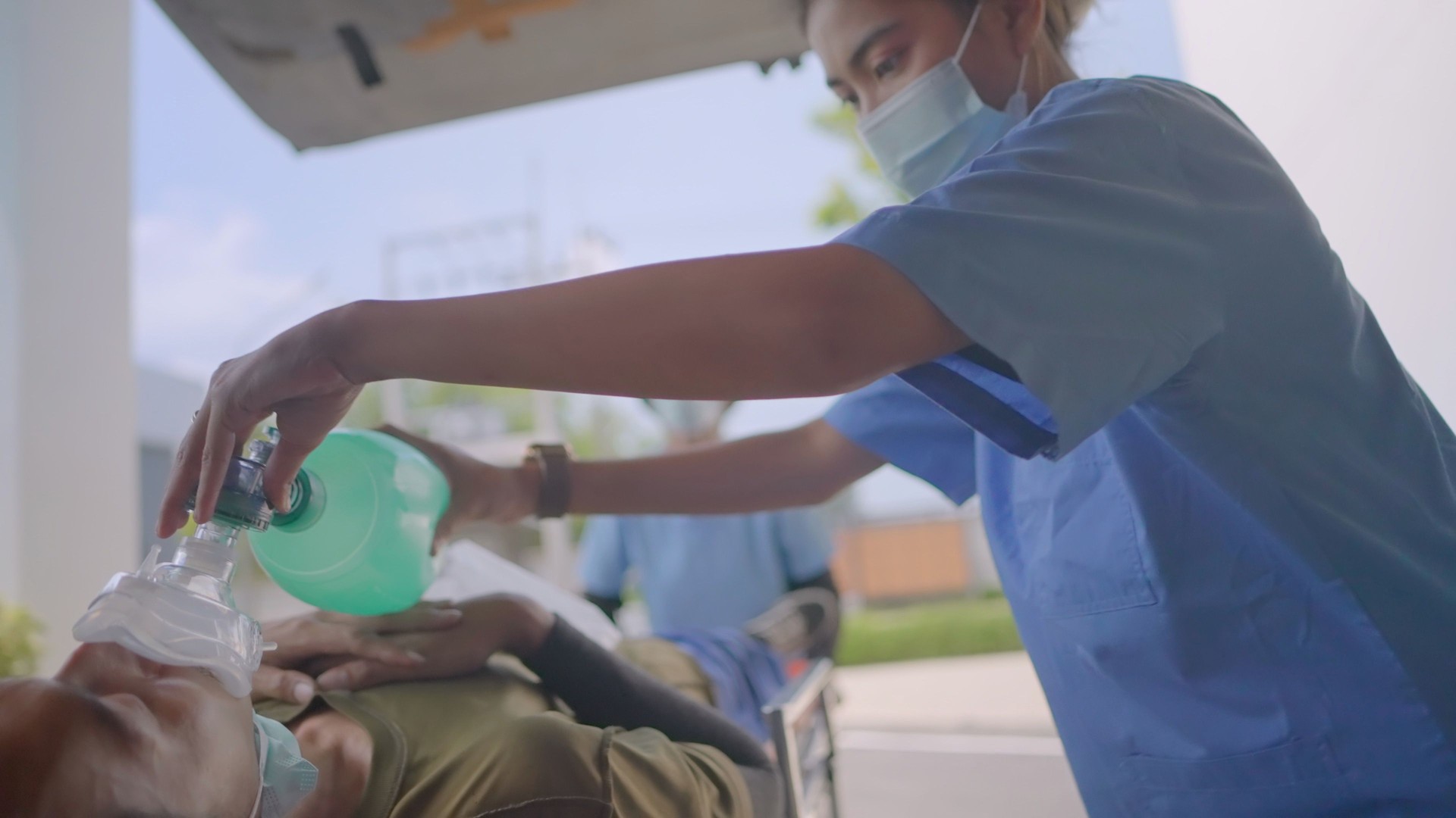Male nurse nurse takes patient experienced an accident and an unconscious, ventilated from an emergency ambulance, hastily pushes a stretcher into the emergency room. Professional medical staff saving lives in emergency department in hospital.